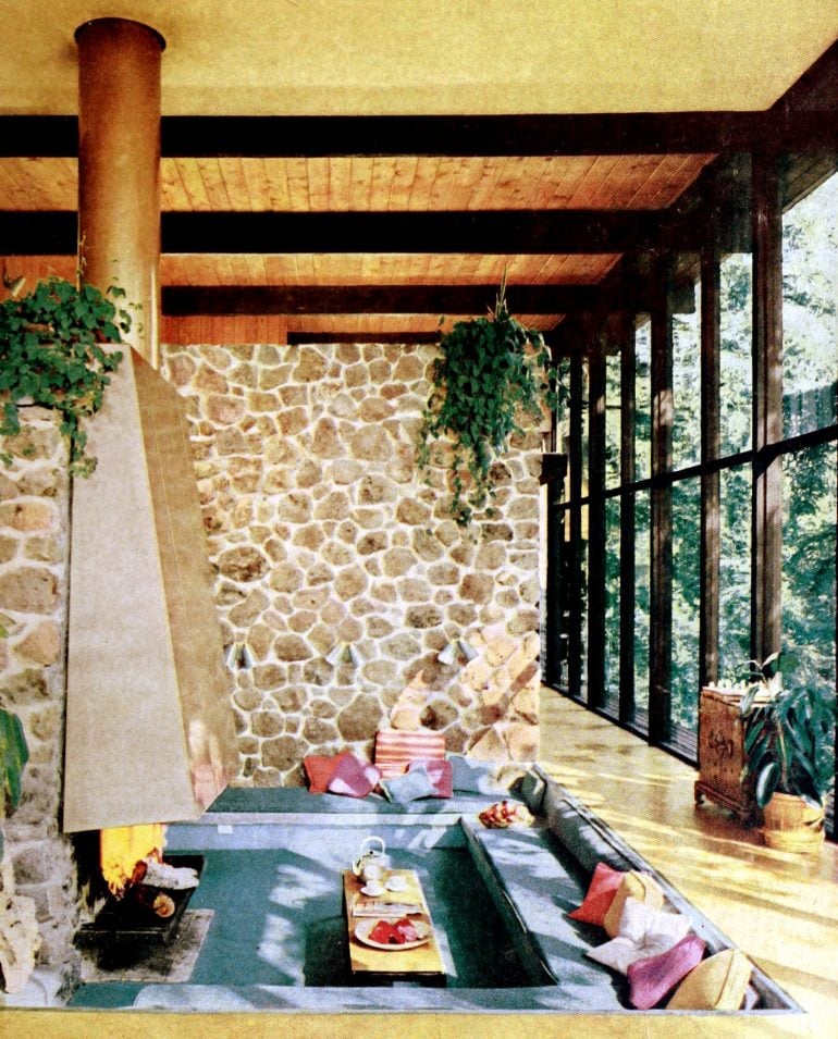 A conversation pit by a fireplace was the center of this two-story living room