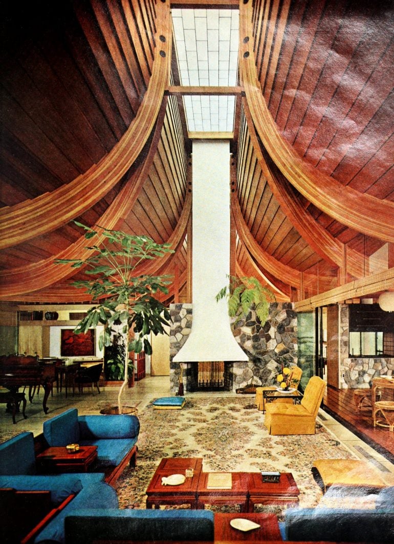 Dramatic living room with a high curved wood ceiling, and skylights above (1964)