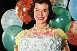 Vintage 1950s woman with a cake and cake recipes