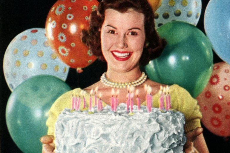 Vintage 1950s woman with a cake and cake recipes
