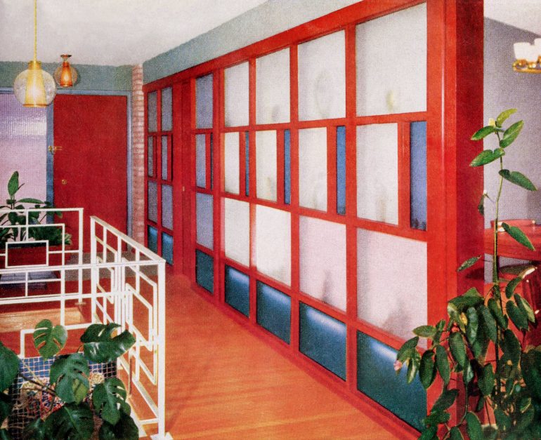 Vintage wood and glass dividing wall added color to a narrow entry hall
